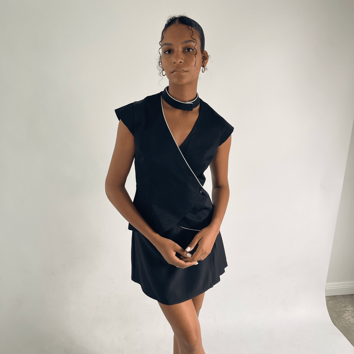 tailored wrap around black vest with ivory piping