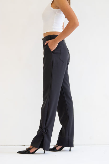 Close up side view of deep grey wool blend pant with ties at hem