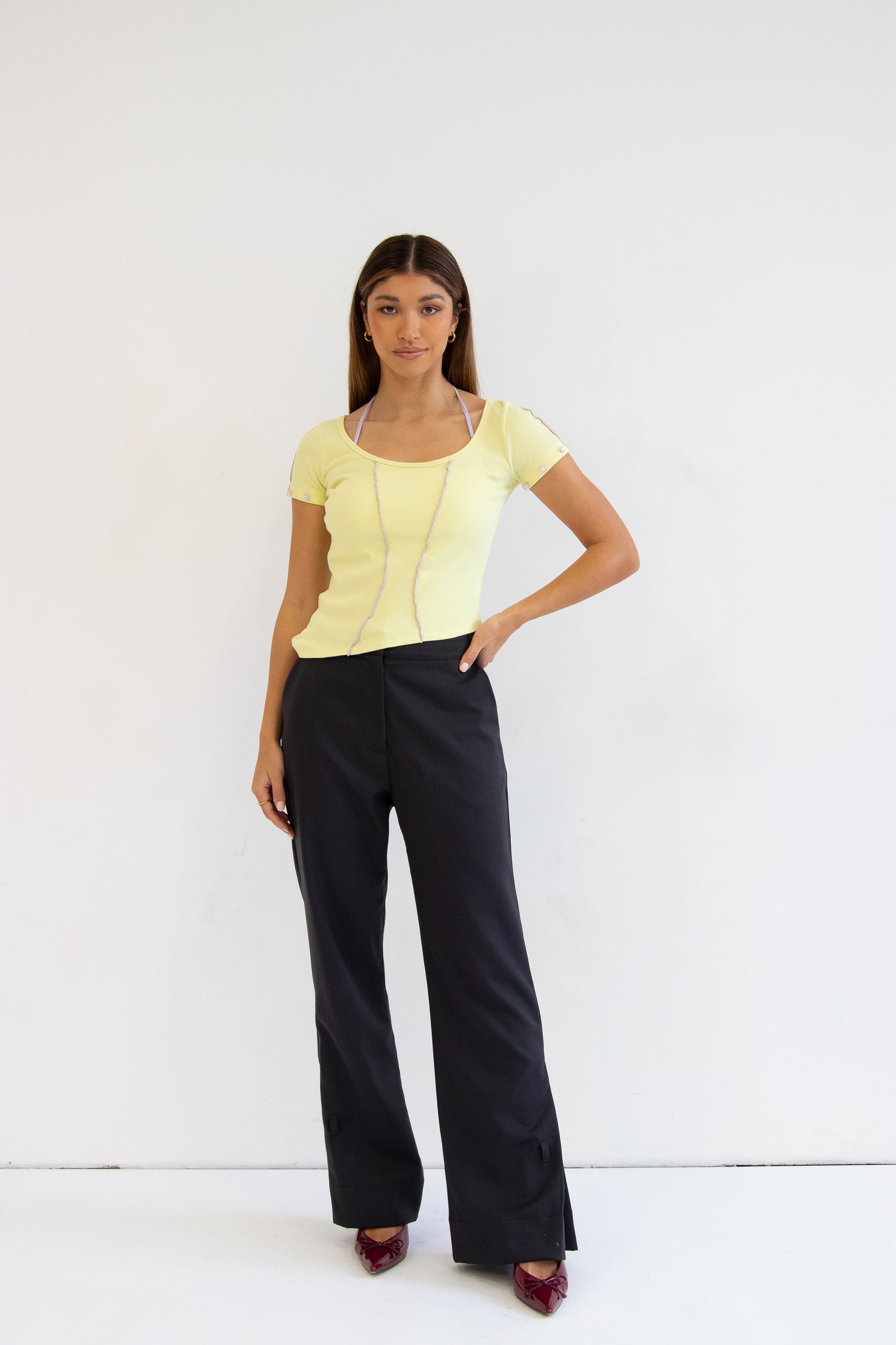 Front view of model wearing dua top with grey heidi pant