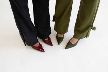 Close up of two models feet showing grey and khaki pants with and without ties at hem