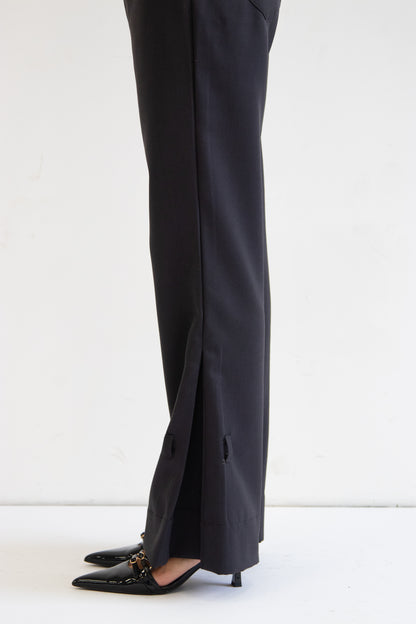Close up side view of pant hem showing box pleat detail