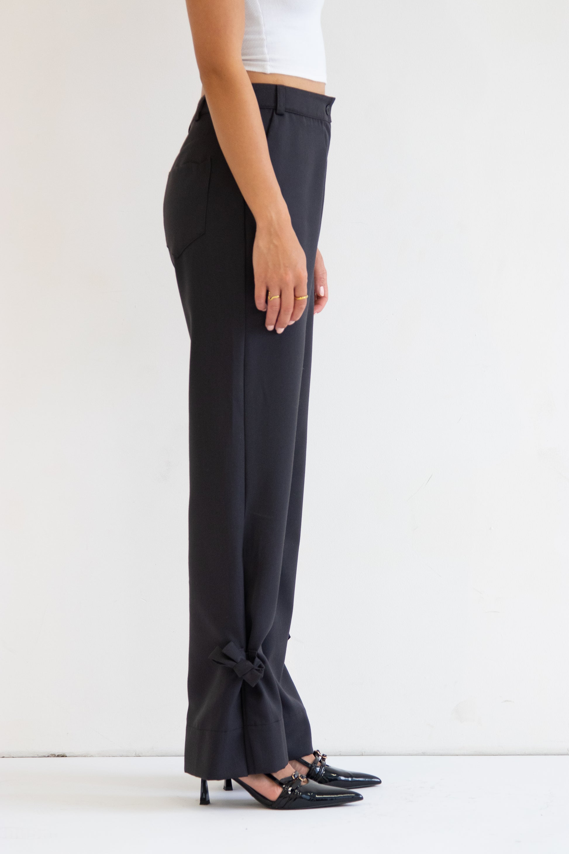 Close up side view of deep grey wool blend pant with ties at hem
